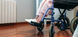 Senior woman in a wheelchair alone in a room